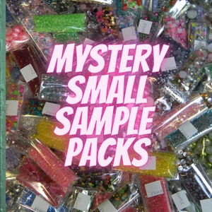 May include: A variety of small sample packs of colorful beads and sequins in clear plastic bags. The bags are labeled "Sample". The image has the text "Mystery Small Sample Packs" in pink.