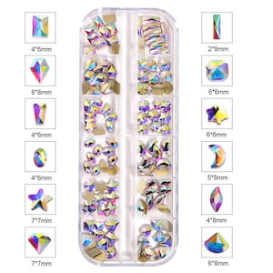 May include: A clear plastic storage box filled with 12 compartments containing various iridescent rhinestones in different shapes and sizes. The box includes a variety of shapes, including stars, moons, ovals, and diamonds. The rhinestones are arranged in rows and columns, and each compartment is labeled with the size of the rhinestones in millimeters.