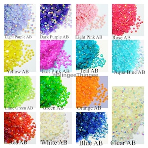 May include: Assortment of 14 colors of AB rhinestones, including light purple, dark purple, light pink, rose, yellow, hot pink, teal, aqua blue, lime green, green, orange, red, white, and clear.