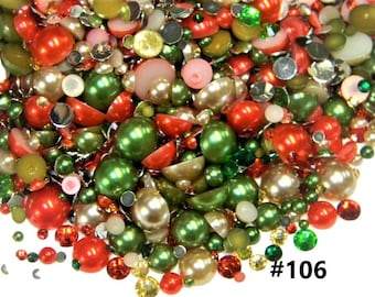 May include: A large assortment of red, green, and white pearl-like beads and rhinestones. The beads are various sizes and shapes. The rhinestones are clear, green, and red. The image includes the text #106.