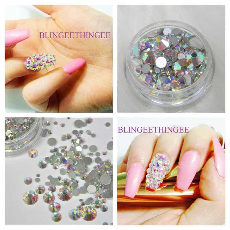 May include: A clear plastic container filled with iridescent clear rhinestones. The rhinestones are of various sizes and shapes. The container is labeled "BLINGEEETHINGEE".