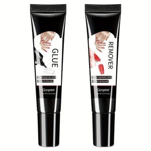 May include: Two black tubes of nail products, one labeled "GLUE" and the other "REMOVER." Each tube features a white label with a hand illustration and product details. The "GLUE" tube states "Quick Drying," while the "REMOVER" tube says "Mild removal."