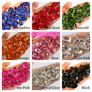 May include: Assortment of colorful glass rhinestones in various shapes and sizes.  The colors include sapphire, red siam, emerald, orange, rose, light pink, hot pink, crystal clear, and black.