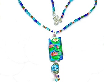 Lamp Works Lily Pond and Flowers Pendant, Matching Glass Beads Necklace, Lamp Works Blue Bead Charm and Crystal Cube Beads in Pendant colors