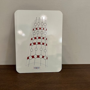 May include: White dry erase board with a black and red illustration of a tower with circles. The text "The Practice Tower" and a website address are printed at the bottom of the board.
