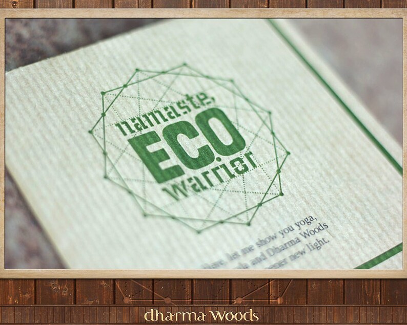 May include: A green and white logo with the text "namaste, ECO Warrior" inside a geometric shape. The logo is printed on a brown paper background.