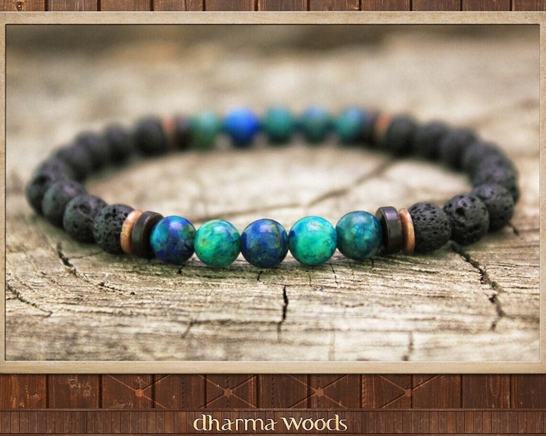 May include: A beaded bracelet featuring a series of porous black lava beads interspersed with smooth, polished spherical beads in shades of deep blue and vibrant turquoise, accented by small copper and dark brown cylindrical spacer beads.