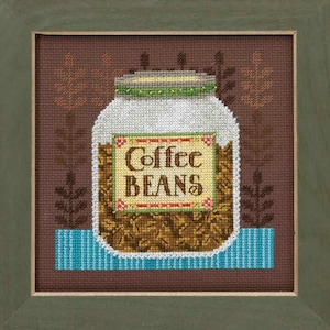 May include: Cross-stitch image of a jar filled with coffee beans. The jar has a white body, a green and gold lid, and a label that reads "Coffee Beans." The background is brown with leaf-like patterns, and the jar sits on a blue and white striped base. The artwork is framed in a green wooden frame.