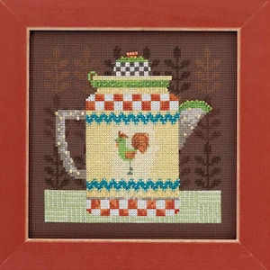 May include: Cross-stitch artwork of a colorful teapot with a rooster design. The teapot is yellow with red and white checkered patterns, turquoise zigzags, and a green lid. The artwork is framed in a red wooden frame.