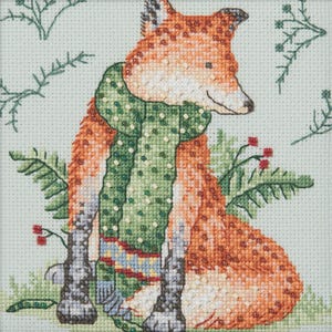 May include: Cross-stitch design of a fox wearing a green scarf with white polka dots. The fox has orange and white fur and is surrounded by green foliage and red berries. The background is a light green color.