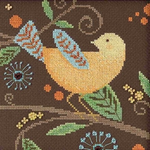 May include: A cross-stitch design of a yellow bird with blue and orange detailing, sitting on a brown branch with green leaves and floral patterns. The background is dark brown, with additional orange and blue floral elements.