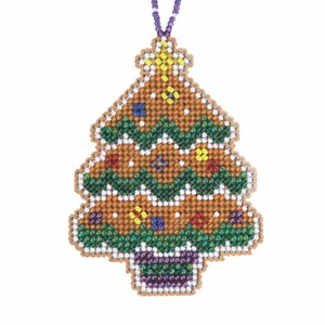 May include: A beaded Christmas tree ornament with a brown base, green garland, and colorful bead accents. The tree is topped with a yellow star and has a purple beaded string for hanging. The ornament is approximately 4 inches tall.
