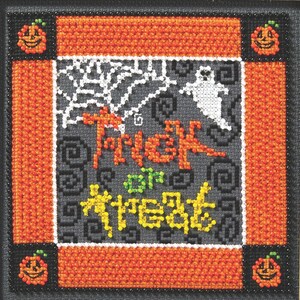 May include: A cross-stitch Halloween design with the words "Trick or Treat" in orange and yellow. The design features a white spiderweb and a ghost on a gray background, framed by an orange border and jack-o'-lanterns.
