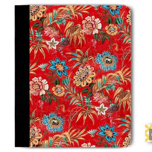 May include: Red binder with a floral pattern featuring colorful flowers and leaves. The binder has a black spine.