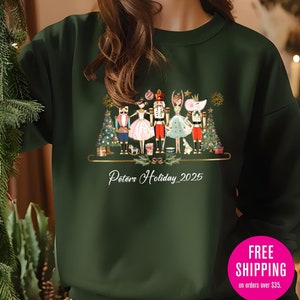 May include: Dark green sweatshirt with a festive design of nutcrackers, a ballerina, and a mouse, with Christmas trees and gifts. The text "Peters Holiday 2025" is printed below the design. A comfortable, seasonal apparel item.