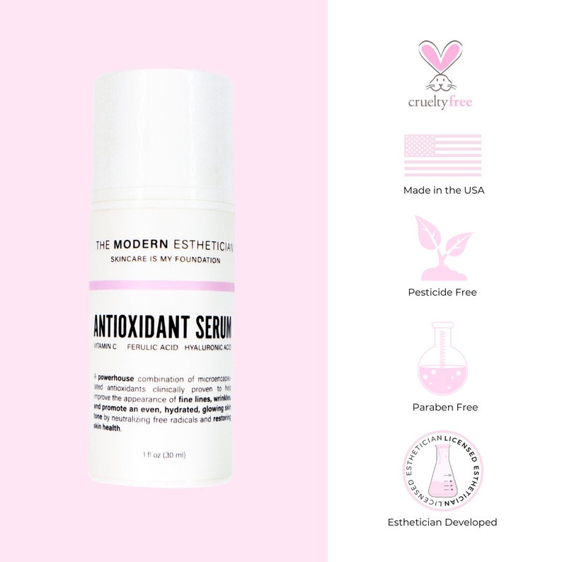 May include: A white bottle of antioxidant serum with a pink label. The label reads "The Modern Esthetician Skincare is My Foundation Antioxidant Serum Vitamin C Ferulic Acid Hyaluronic Acid". The bottle is 1 fl oz (30 ml). The bottle is on a pink background. The image also includes several icons indicating that the product is cruelty-free, made in the USA, pesticide-free, paraben-free, and esthetician developed.