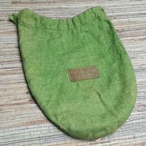 May include: A green fabric drawstring bag with a brown leather tag that reads "Tiffany & Co. New York".