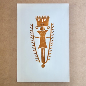 May include: A tan-colored print on a white background. The print features a stylized figure with a crown, a central body, and two flanking elements. The design has a symmetrical layout, with a vertical orientation. The artwork appears to be a linocut or woodcut print.