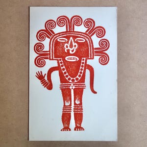 May include: A red and white print of a stylized figure with a headdress and necklace. The figure has a rectangular head with a face and is standing on a light blue background. The figure is waving with one hand.