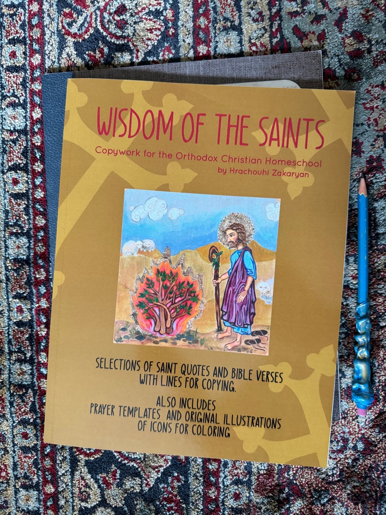 May include: A gold-colored book titled "Wisdom of the Saints" with a colorful illustration of a saint holding a staff and a sheep. The book is for Orthodox Christian homeschool and includes selections of saint quotes and bible verses with lines for copying, prayer templates, and original illustrations of icons for coloring.