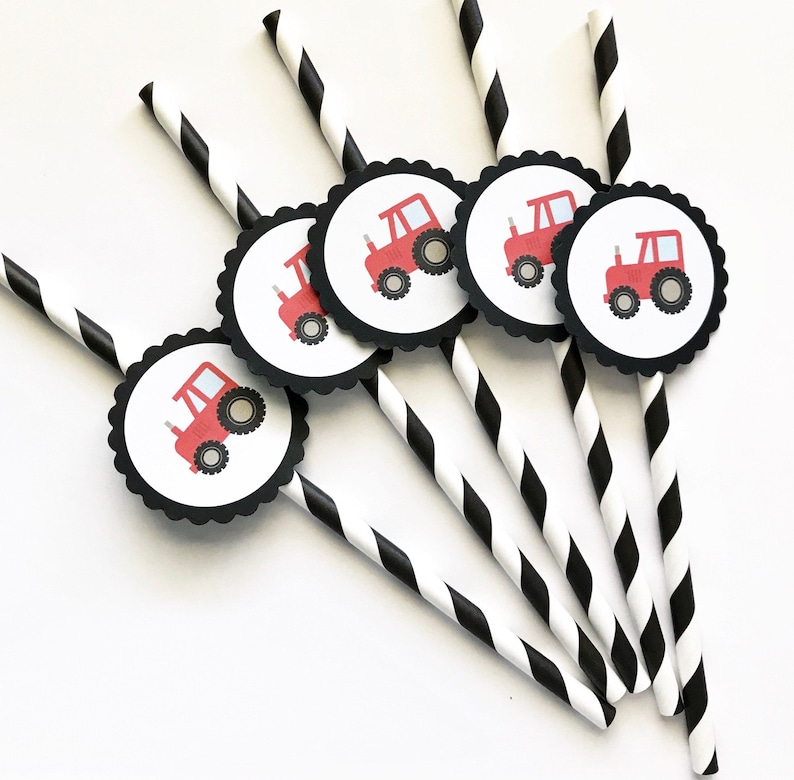 May include: Set of six black and white striped paper straws with red tractor party favor stickers. The stickers are round with a white background and black scalloped edges.