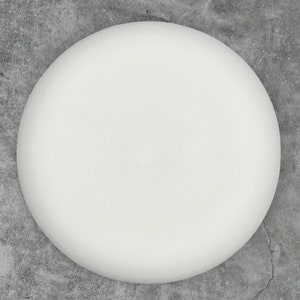 May include: A plain white ceramic plate, perfect for serving a variety of dishes.