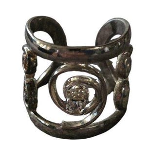 May include: A silver-toned ring with a unique, open design. The ring features a central spiral element with a small, clear stone, and decorative accents. The band has an open design with curved sections.