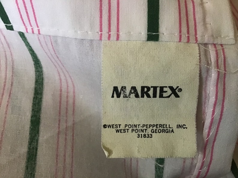 May include: White and pink striped fabric with a green stripe. A white tag with black text reads "MARTEX" and "WEST POINT-PEPPERRELL, INC. WEST POINT, GEORGIA 31833"
