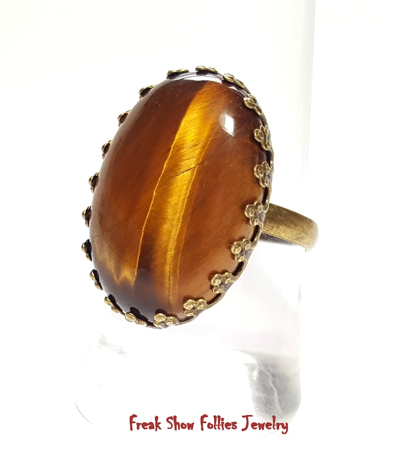 oval golden tigers eye gemstone ring in a bronze crowned prong setting