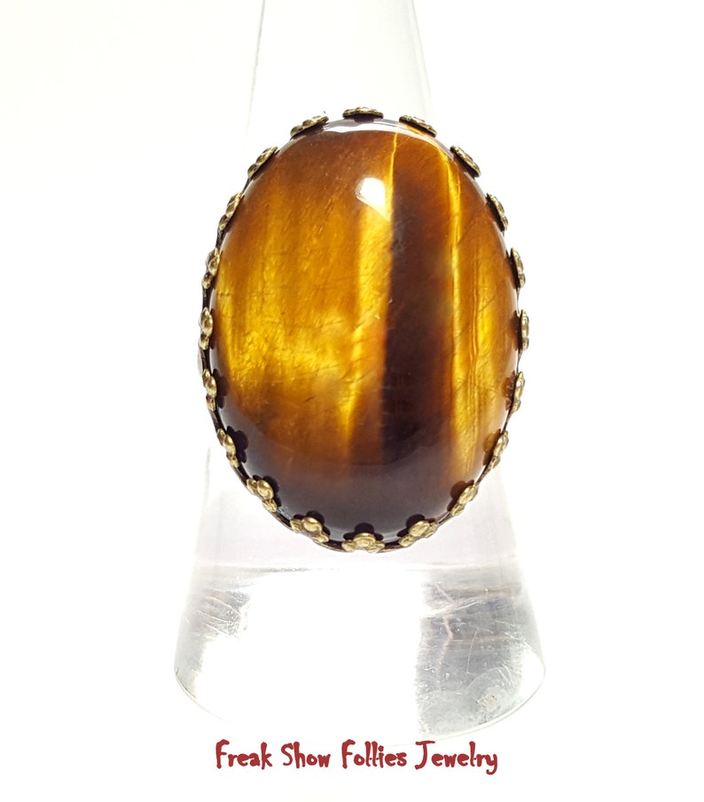oval golden tigers eye gemstone ring in a bronze crowned prong setting