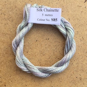 May include: A skein of light green and purple silk chainette embroidery thread. The thread is 5 meters long and the color number is S85.