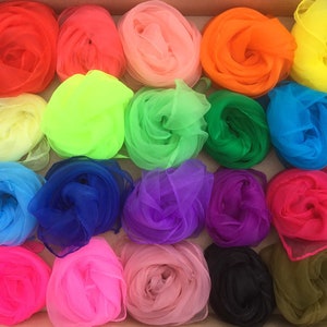 May include: A collection of 20 brightly colored sheer fabric scarves arranged in a box. The scarves are in various colors, including red, orange, yellow, green, blue, purple, pink, and black.