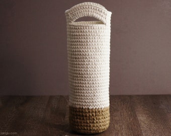 May include: A white crocheted storage basket with a brown crocheted base. The basket has a handle at the top.