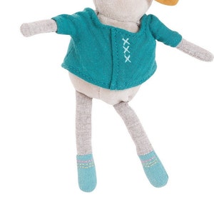 May include: A gray plush toy with a teal jacket and blue shoes. The jacket has white stitching and the shoes have pink and green stitching.