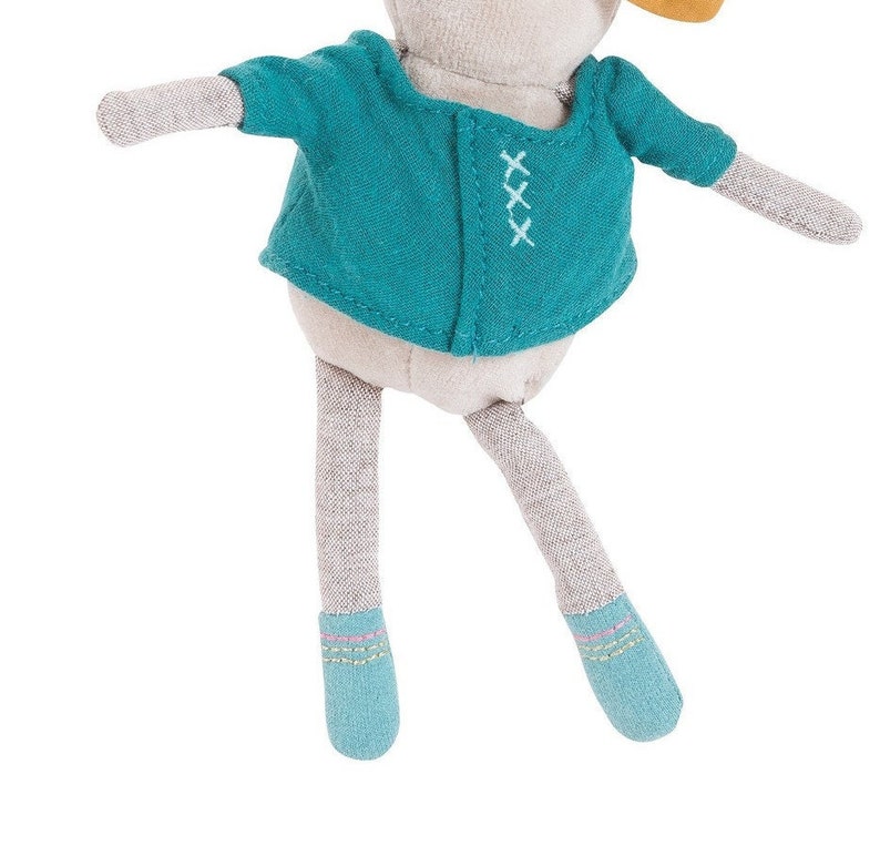 May include: A gray plush toy with a teal jacket and blue shoes. The jacket has white stitching and the shoes have pink and green stitching.