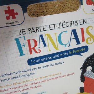 K&ouml;nnte beinhalten: Ein farbenfroher Buchumschlag mit dem Titel "Je parle et j'&eacute;cris en Fran&ccedil;ais" und dem Text "Ich kann Franz&ouml;sisch sprechen und schreiben!" Der Buchumschlag zeigt eine Comicfigur, die ein Buch mit dem Titel "Fran&ccedil;ais" liest.