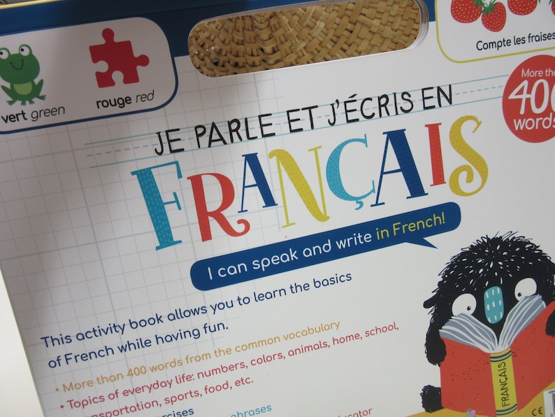 K&ouml;nnte beinhalten: Ein farbenfroher Buchumschlag mit dem Titel "Je parle et j'&eacute;cris en Fran&ccedil;ais" und dem Text "Ich kann Franz&ouml;sisch sprechen und schreiben!" Der Buchumschlag zeigt eine Comicfigur, die ein Buch mit dem Titel "Fran&ccedil;ais" liest.