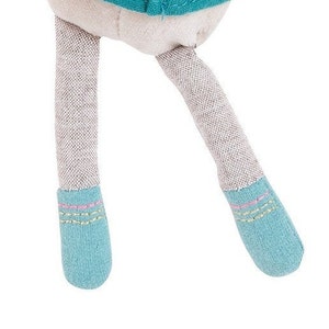 May include: A pair of blue and gray fabric doll legs with pink and yellow stitching on the ankles.