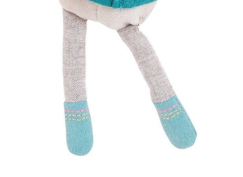 May include: A pair of blue and gray fabric doll legs with pink and yellow stitching on the ankles.