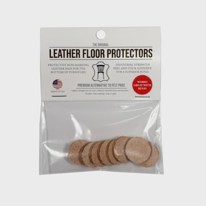 May include: A package of round, tan leather floor protectors. The packaging reads "Leather Floor Protectors" and "Premium Alternative to Felt Pads." The product is designed to protect floors and furniture. Made in the USA.