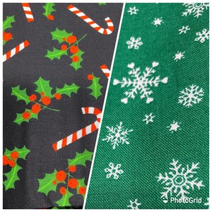 May include: Two fabric swatches with Christmas patterns. The first swatch is black with red and green holly leaves and candy canes. The second swatch is green with white snowflakes.j