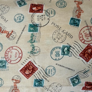 May include: Tan fabric with a repeating pattern of vintage postage stamps, postmarks, and postcard text in red, teal, and black. The design includes stamps, postmarks, and the word "POST CARD".