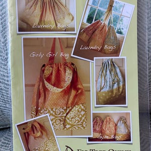 May include: A sewing pattern for making various bags, including laundry bags, a girly girl bag, gym bags, and a makeup bag. The pattern is titled "Easiest Accessory Bags Ever" and is from Fig Tree Quilts.