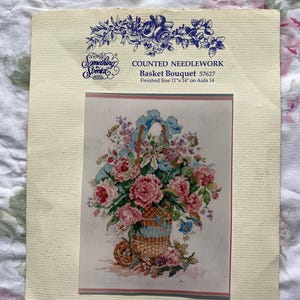May include: Counted cross stitch pattern for a basket of flowers. The pattern is called "Basket Bouquet" and is from the "Something Special" brand. The finished size is 11 inches by 14 inches on Aida 14 count fabric.