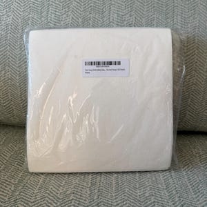 May include: A package of white tear-away embroidery stabilizer sheets. The sheets are in a clear plastic wrapper with a label that reads "Tear Away Embroidery Stab... Fits 4x4 Hoops 100 Sheets New". The package is rectangular and appears to be new.