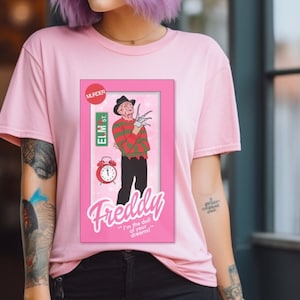 Freddy doll tshirt, horror movie doll tshirt, funny Halloween graphic tee, pink spooky shirt, retro aesthetic, scary characters