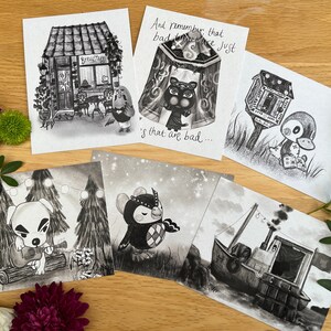 May include: Five black and white illustrated postcards featuring characters from the Animal Crossing video game series. The postcards feature a coffee shop, a tent, a mailbox, a character playing a guitar, and a boat.