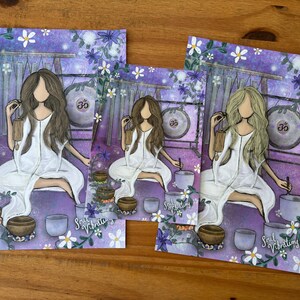 May include: Three art prints featuring a woman in a white dress meditating with singing bowls and a gong. The background is purple with floral accents. The text "Soul Vibrating" is visible on the prints.