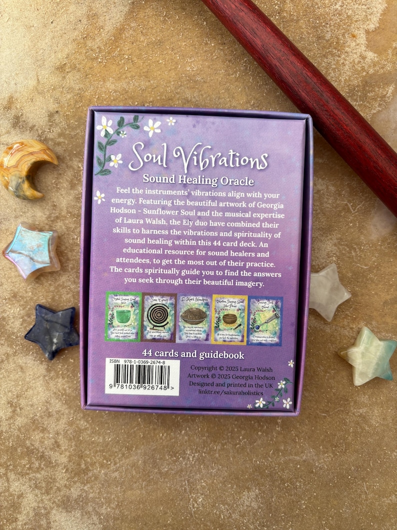 May include: A Soul Vibrations Sound Healing Oracle card deck with a purple box featuring floral accents and the text "Soul Vibrations." The deck includes 44 cards and a guidebook. Decorative star-shaped crystals surround the box.