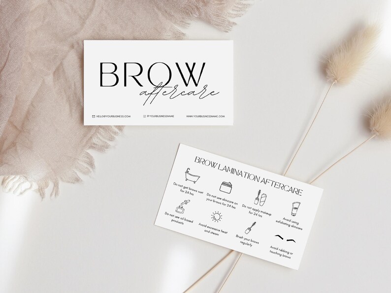 May include: A white card with the text "BROW aftercare" in black. The card also includes a list of instructions for brow lamination aftercare, including avoiding water, heat, and certain products. The instructions are illustrated with simple black and white icons.